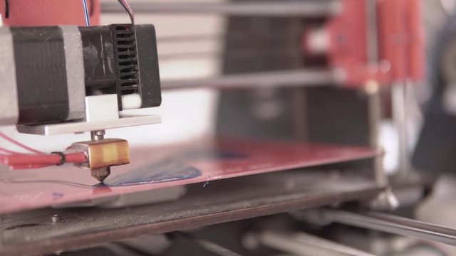 Shallow depth fof field Close up of a home made 3d printer working on a plastic face mask prototype design with filament