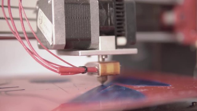 Shallow depth fof field Close up of a home made 3d printer working on a plastic face mask prototype design with filament