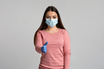 Young Woman In Medical Mask And Gloves Extending Hand For Handshake