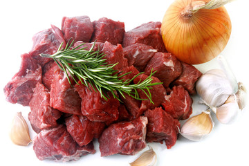 pile of cube chopped pile raw diced beef cubes with spices isolated over white background