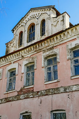 Old abandoned building of the 18th century. Facade of an ancient house.
