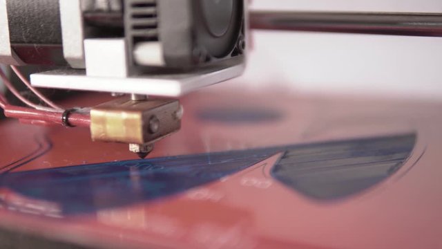 Shallow depth fof field Close up of a home made 3d printer working on a plastic face mask prototype design with filament diagonals