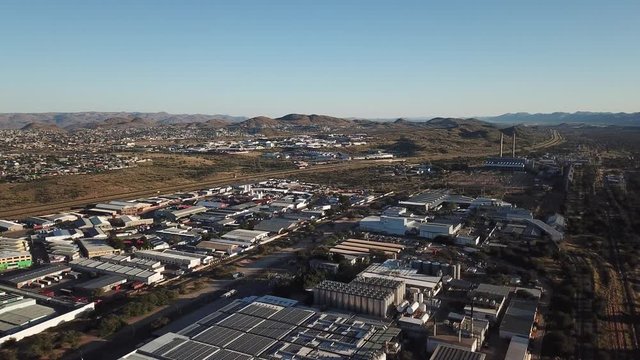 4K bright summer morning aerial video of Namibia Brewery beer factory and its hangars located in Windhoek Northern Industrial area, Khomas Region, central Namibia, southern Africa