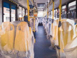 new bus interior with plastics on the seats


