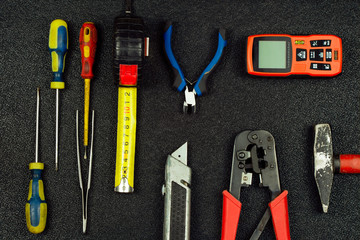 Set of hand repair tools on a black background. Do it yourself (DIY) concept. Top view