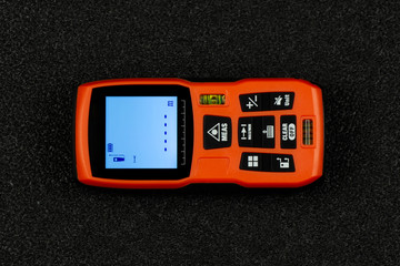 Hand holding construction roulette, calliper and laser range finder. Laser measuring tool. Top view. Flat lay