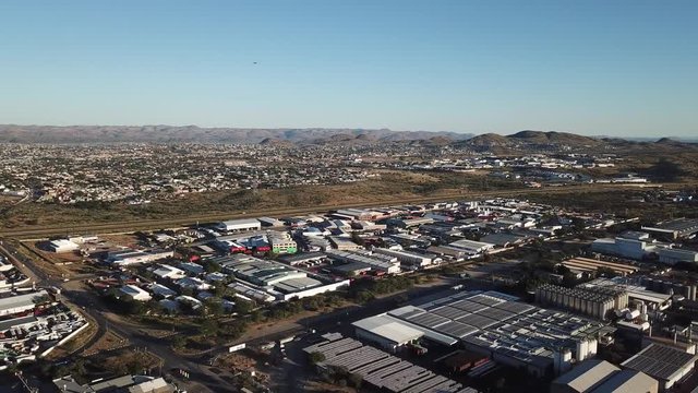4K bright summer morning aerial video of Namibia Brewery beer factory and its hangars located in Windhoek Northern Industrial area, Khomas Region, central Namibia, southern Africa