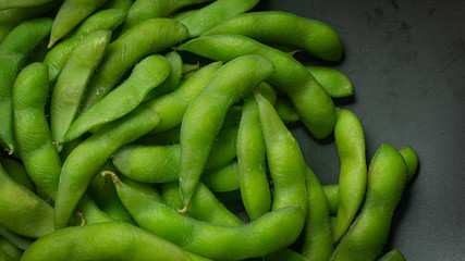 Edamame  in black plate top view image for food content.