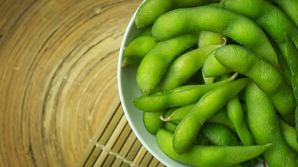 Edamame  in white bowl top view image for food content.