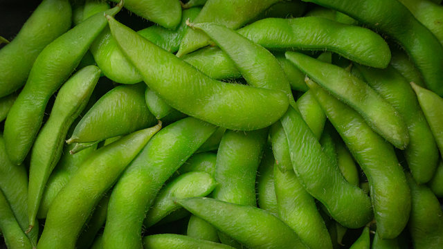 Edamame  in black plate top view image for food content.