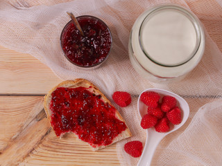 
raspberry jam on a wooden background