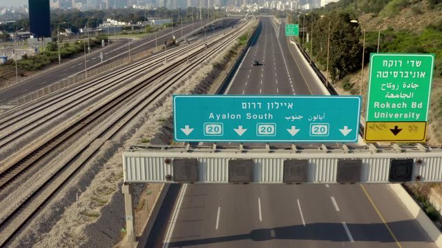 One car driving on empty highway due to Coronavirus Pandemic, Tel Aviv, Israel, aerial reveal