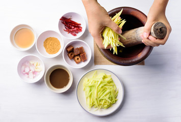 Thai food cooking, spicy green mango salad (Tum Ma Muang), Top view