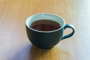 teapot and cup of tea on wooden table