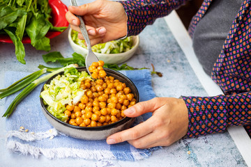 Cooked chickpea beans with vegetables salad. Vegan healthy food.
