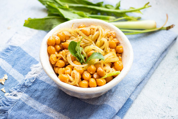 Cooked chickpea beans with fried onion. Vegan healthy food.