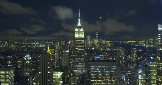 Empire State Building, New York City, at night in Manhattan, in a landscape illuminated by thousands of bright windows coming from a multitude of skyscrapers.