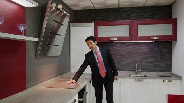 WS DS TS Salesman showing kitchen furniture in showroom