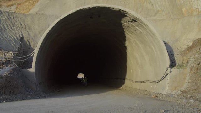 WS Two Construction Workers Walking Out Of Tunnel