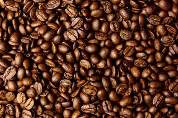 Roasted coffee beans close up background 
