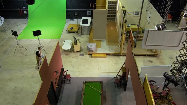 HA WS TS Producer and stage hand walking through TV studio