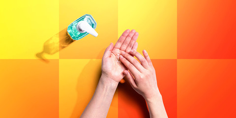 Applying sanitizer gel - healthcare and hygiene concept