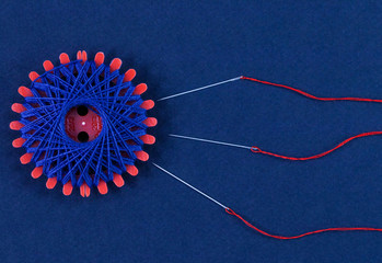 Needles with thread in the form of conception, a delicate theme.