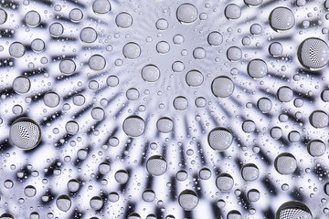 Abstract lines through drops of water on a glass, macro view