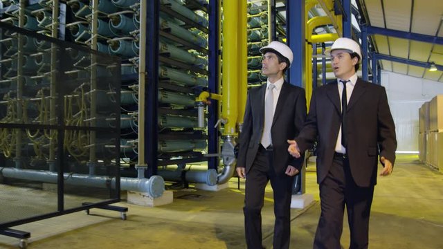 DS TS WS&nbsp;Two businessmen walking through industrial building