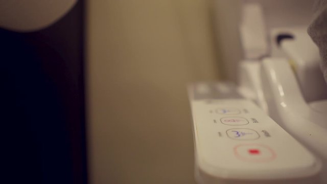 Man cleaning with bidet toilet attachment