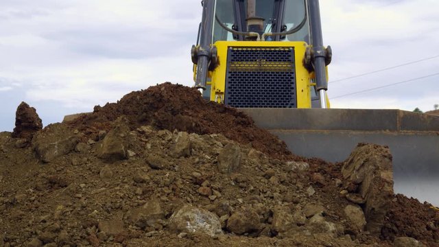 MS CU Front view of bulldozer leveling earth