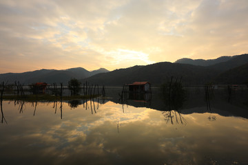 Floating house with the Sunrise in the reservoir Korea. Mungwang, Chungbuk, Korea