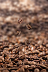 Coffee Beans Falling ,Roasted coffee beans close up ,isolated on brown color background