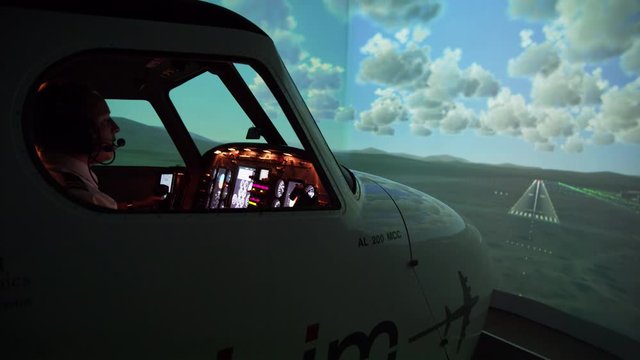 WS Side view of pilots in flight simulator during approach and landing