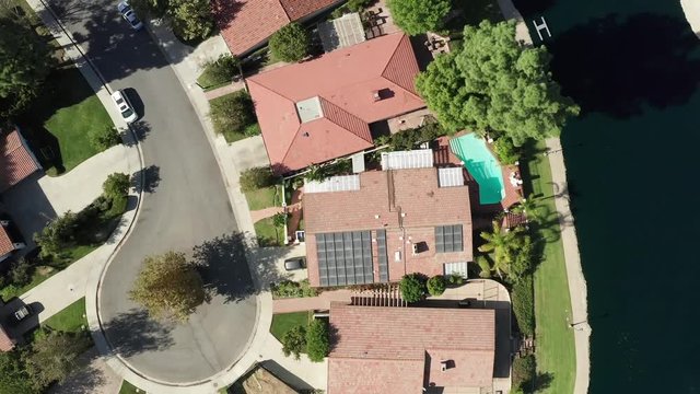 Aerial View of Luxury House With Solar Panel Array on Rooftop by Calabasas Lake