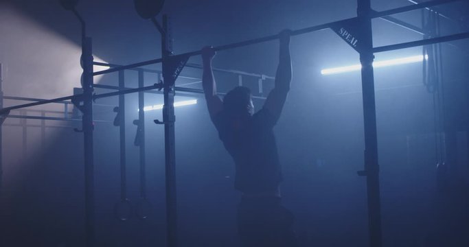 Male body builder doing pull ups