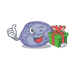 Smiling blue planctomycetes cartoon character having a green gift box