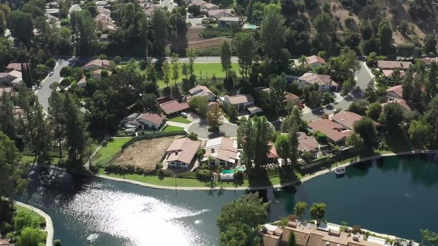 Calabasas luxury houses beside lake in wealthy neighborhood, aerial view