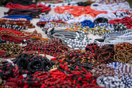 Colorful beads, necklaces and bracelets are laid out on a table for sale at a street market in Ghana, West Africa.