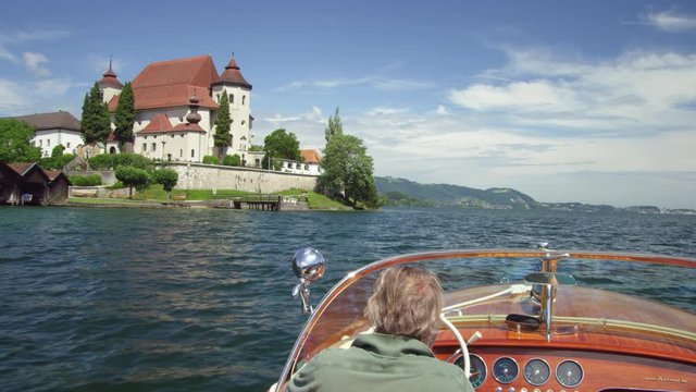 POV WS Motorboat on Traunsee lake with view of church housing Fischerkanzel