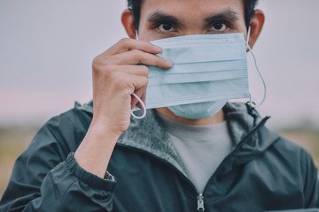 Asian man holding face mask,surgical mask protect corona virus covid 19