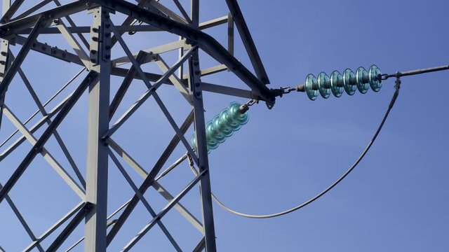 MS ZI CU Electricity pylon against blue sky, zoom in to insulator
