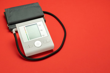 Blood pressure check. Health monitor for check doctor blood pressure isolated on red background....