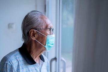 Grandfather wearing facial mask at home