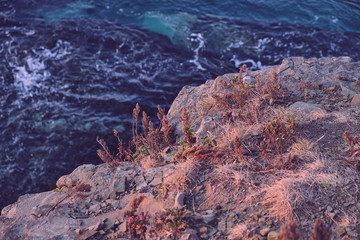 Fototapeta na wymiar top view from the edge of the cliff on the turquoise sea at sunrise hour