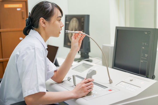 Asian Radiologist working at Fluoroscopy console, Medical concept 