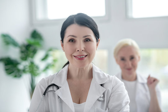 Close up picture of two positive female doctors