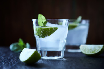 Gin and Tonic on black stone background. Close up.