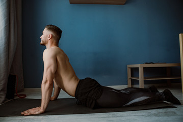 guy stretching on a  floor at home