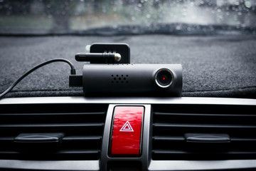 Car video camera (dash cam) and emergency light button in car ,Concept of safety camera for car...
